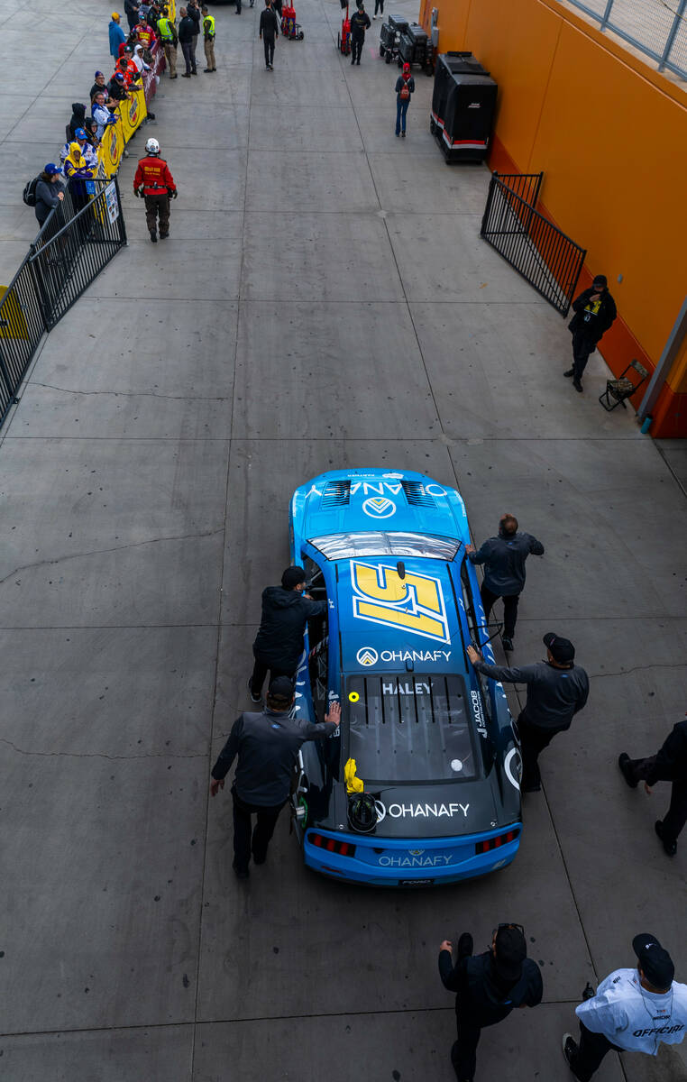 The crew for Justin Haley, #51 with team Rick Ware Racing Ford, brings his car to the track bef ...