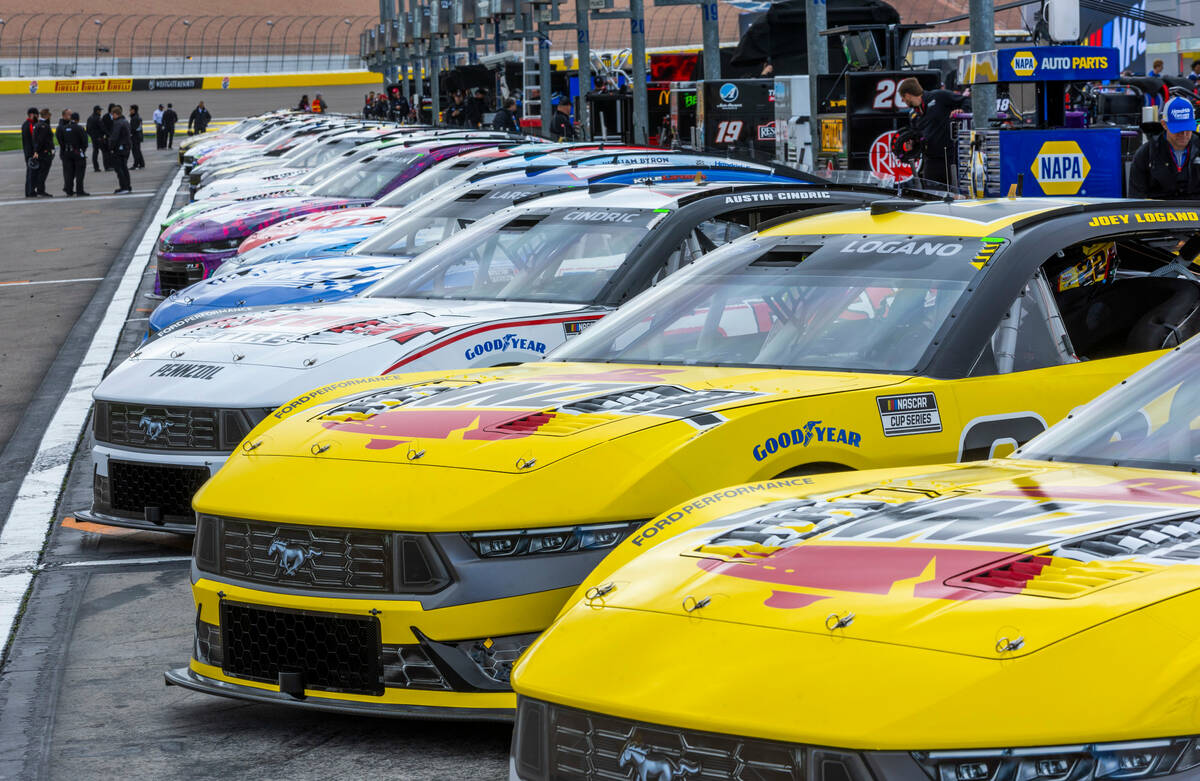 NASCAR racing cars are lined up in the post area before the Pennzoil 400 practice/qualifying at ...