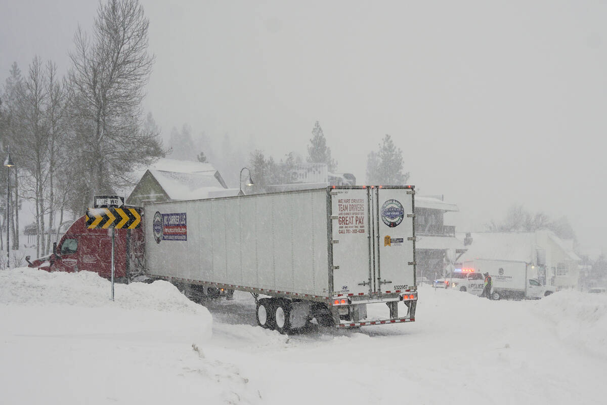 Vehicles make their way along a snow-covered road during a storm, Saturday, March 2, 2024, in T ...
