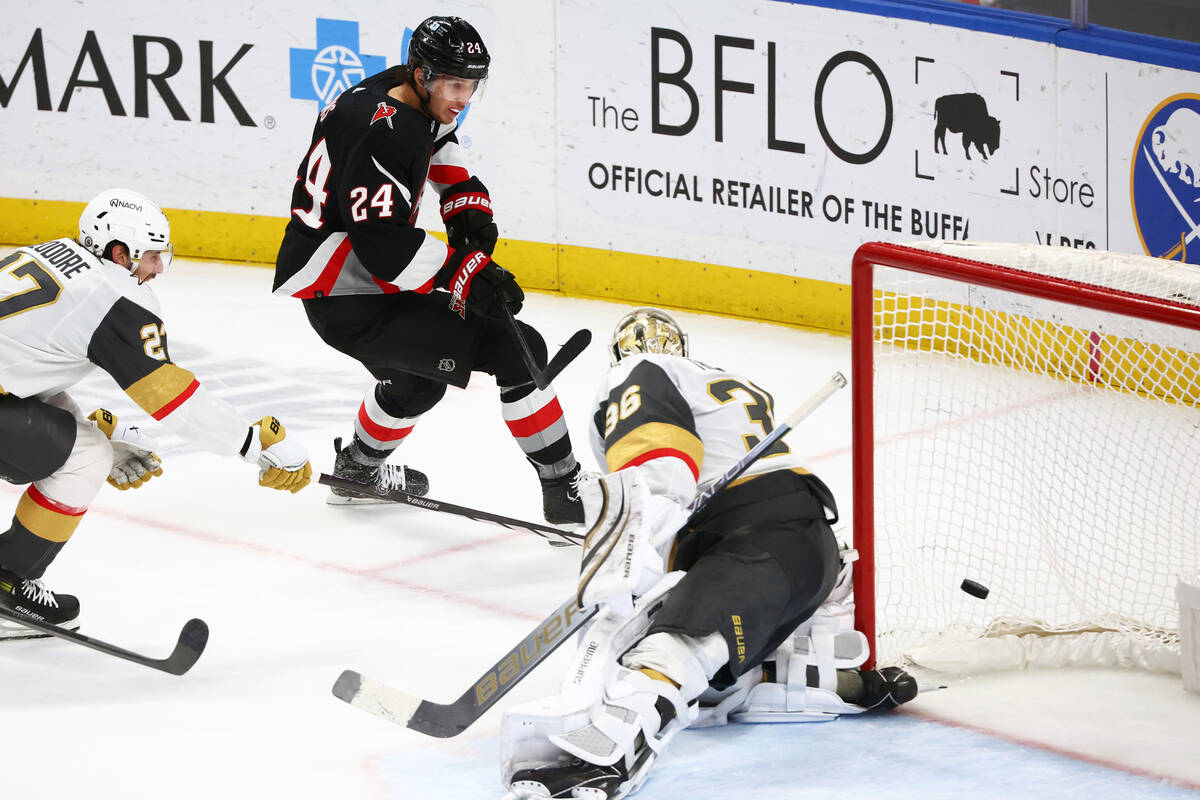 Buffalo Sabres center Dylan Cozens (24) puts the puck past Vegas Golden Knights goaltender Loga ...