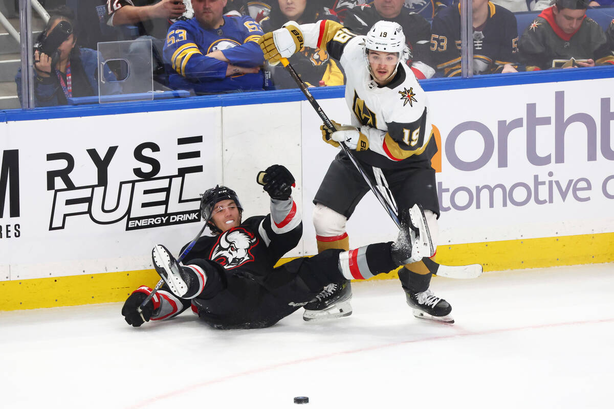 Buffalo Sabres center Peyton Krebs (19) is checked by Vegas Golden Knights center Brendan Briss ...