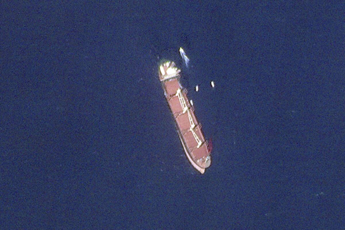 This satellite image taken by Planet Labs PBC shows the Belize-flagged ship Rubymar in the Red ...
