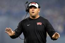 UNLV Rebels head coach Barry Odom communicates from the sidelines during the first half of the ...