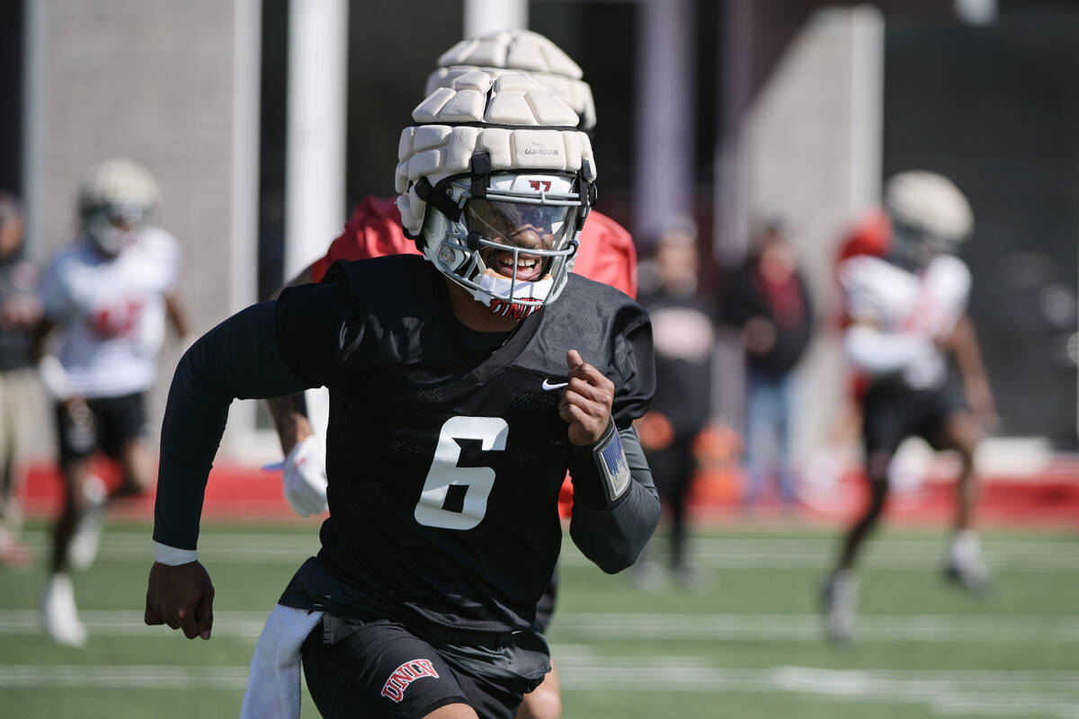 UNLV quarterback Hajj-Malik Williams warms up during the first day of spring practice Saturday, ...