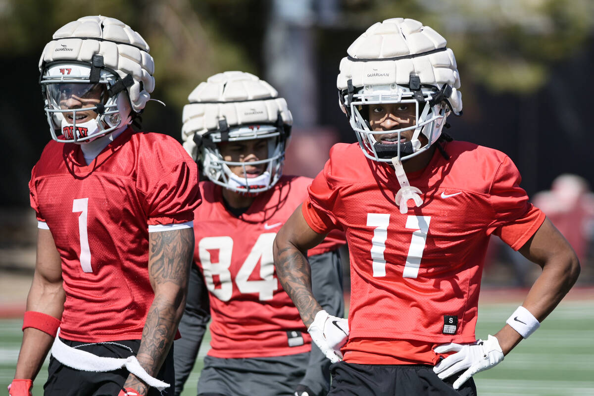From left, UNLV wide receivers Casey Cain, Corey Thompson Jr., and Ricky White III take part in ...