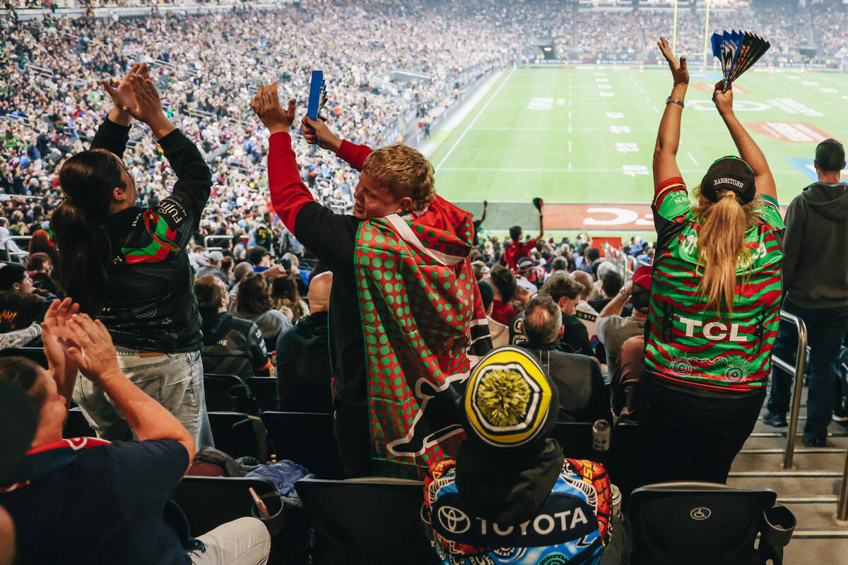 Rabbitohs fans celebrate a try during the NRL Telstra Premiership season opening game between t ...
