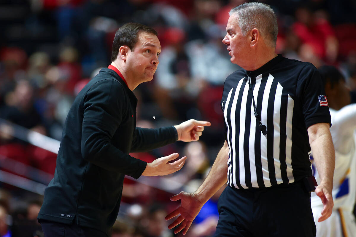 UNLV Rebels head coach Kevin Kruger loses his gum while arguing with a referee during the first ...