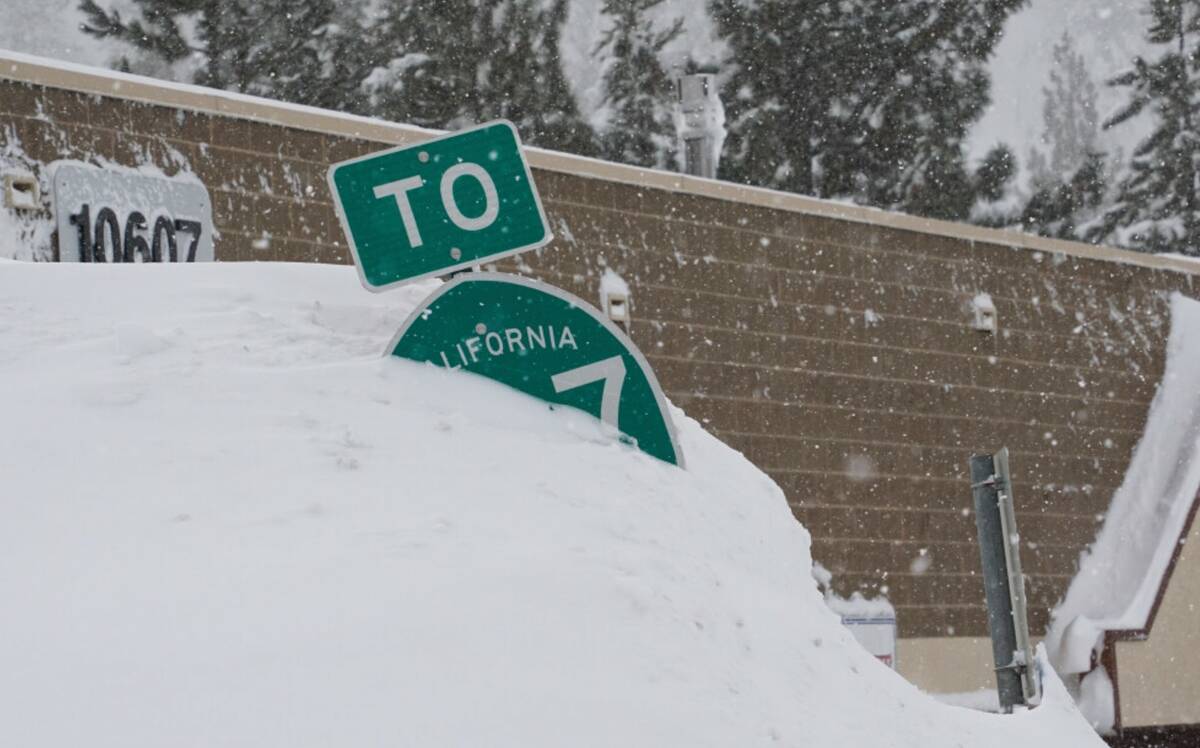 A highway sign is covered in snow during a storm, Sunday, March 3, 2024, in Truckee, Calif. (AP ...
