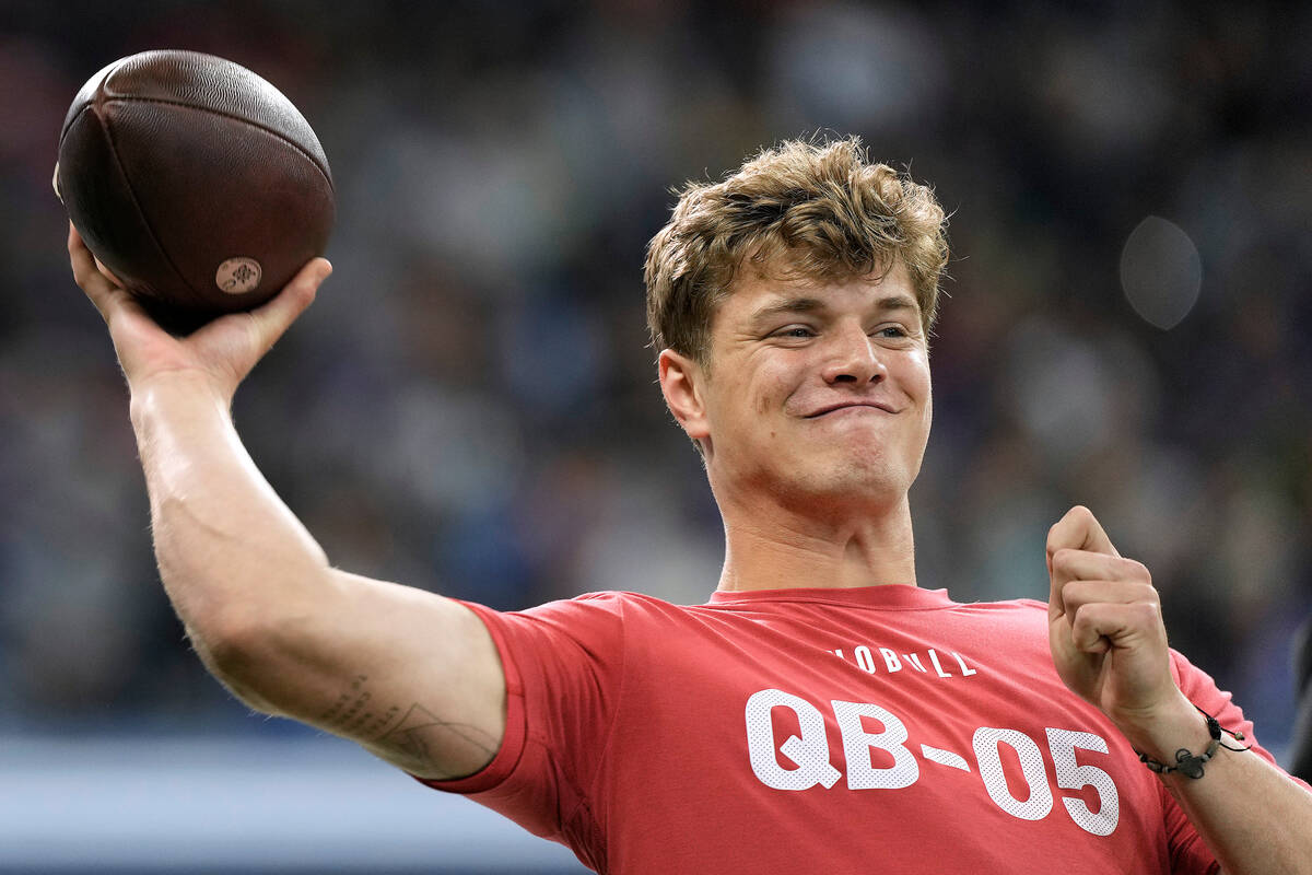 Michigan quarterback J.J. McCarthy throws during the NFL football scouting combine, Saturday, M ...