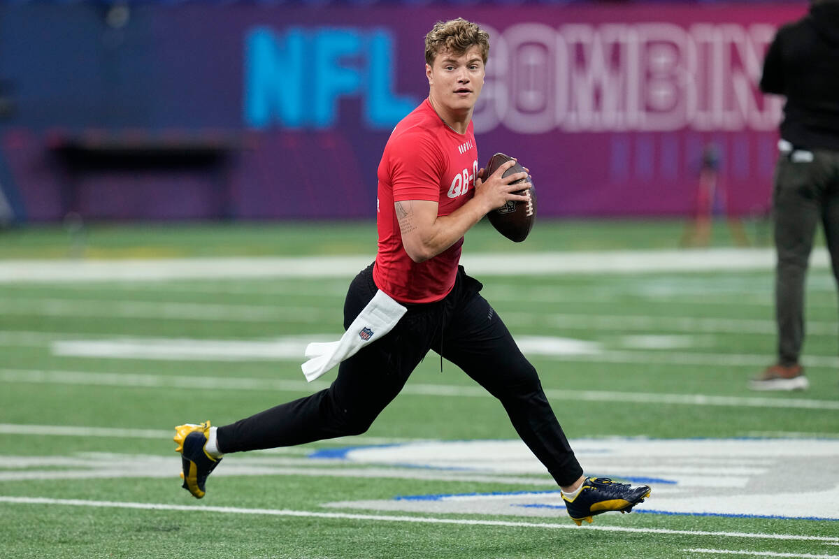 Michigan quarterback J.J. McCarthy runs a drill at the NFL football scouting combine, Saturday, ...