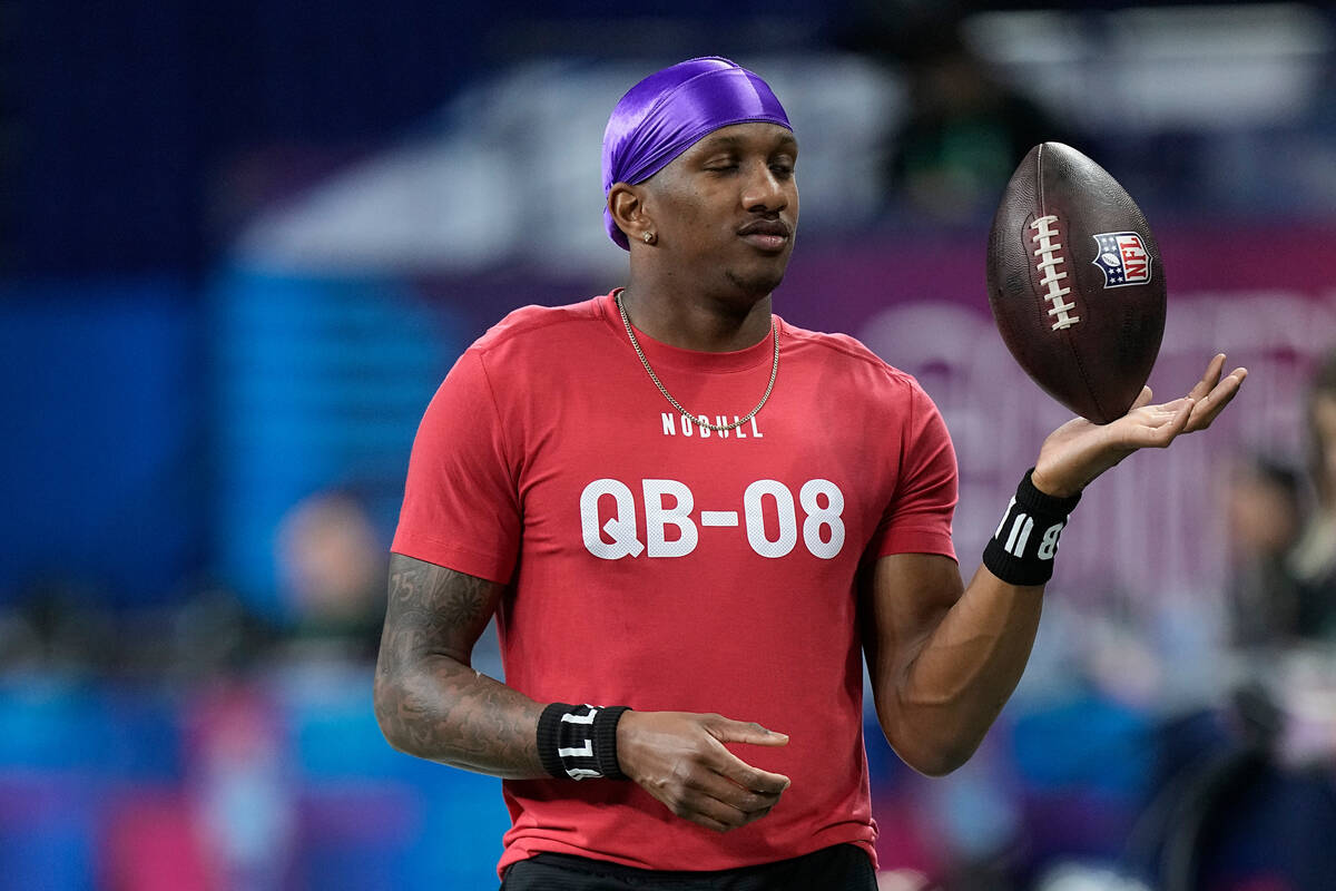 Washington quarterback Michael Penix runs a drill at the NFL football scouting combine, Saturda ...