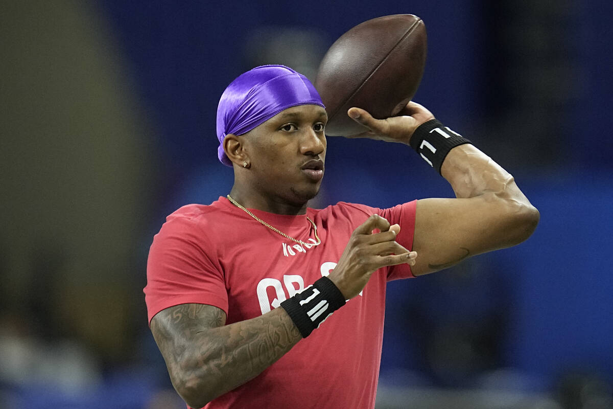 Washington quarterback Michael Penix runs a drill at the NFL football scouting combine, Saturda ...