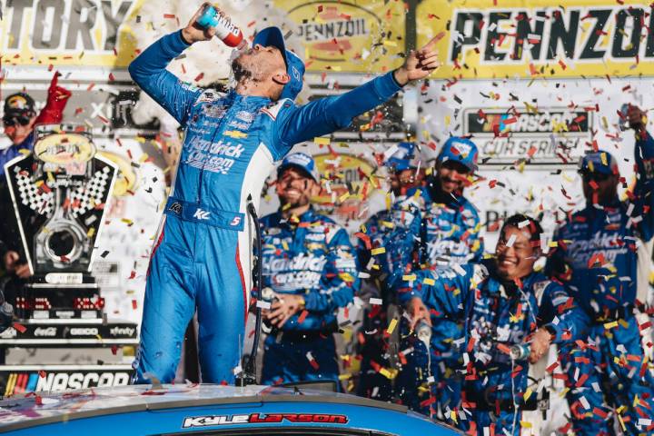 Kyle Larson chugs a Prime energy drink to celebrate winning the Pennzoil 400 NASCAR Cup Series ...