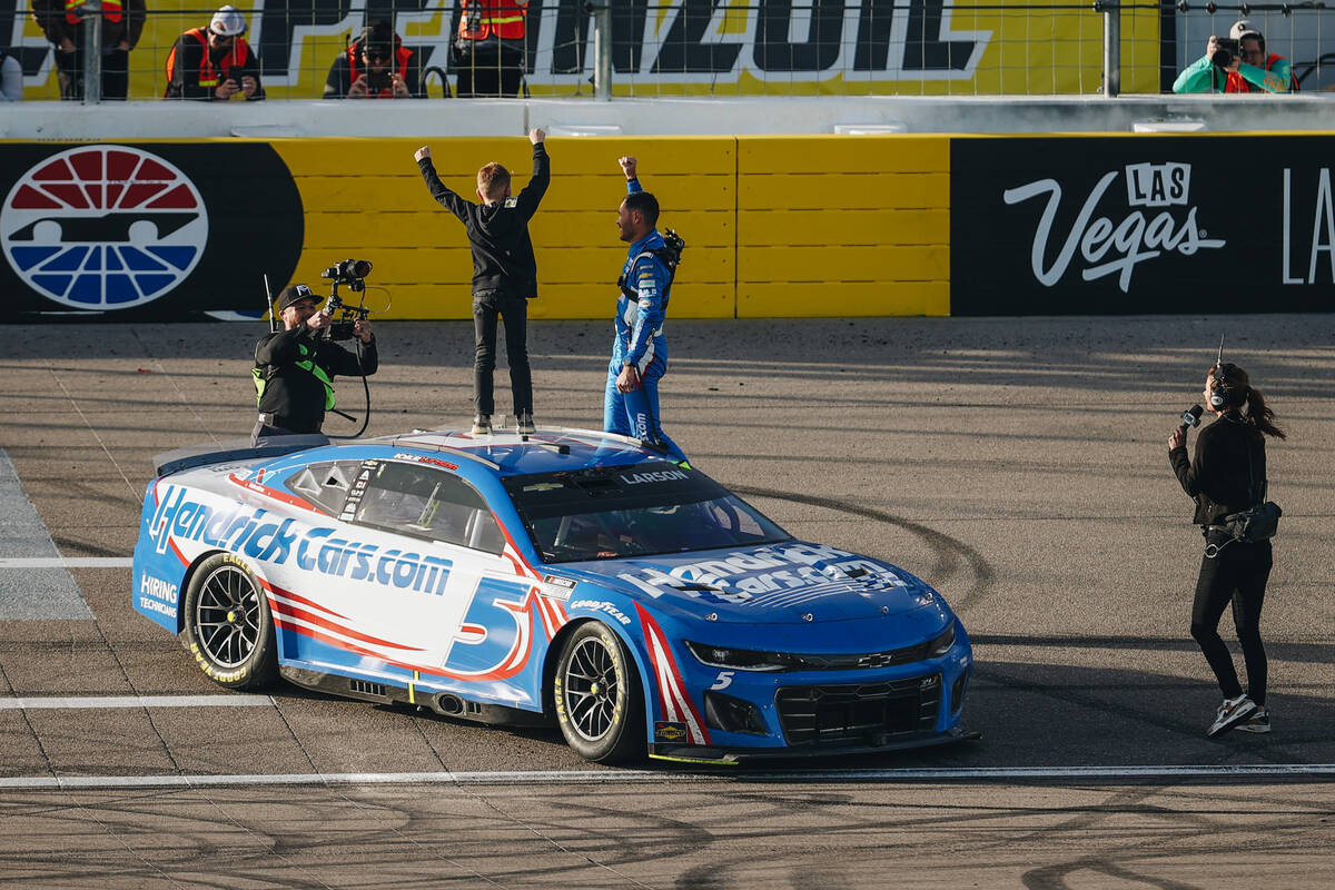 Kyle Larson celebrates winning the Pennzoil 400 NASCAR Cup Series race with his son, Owen Larso ...