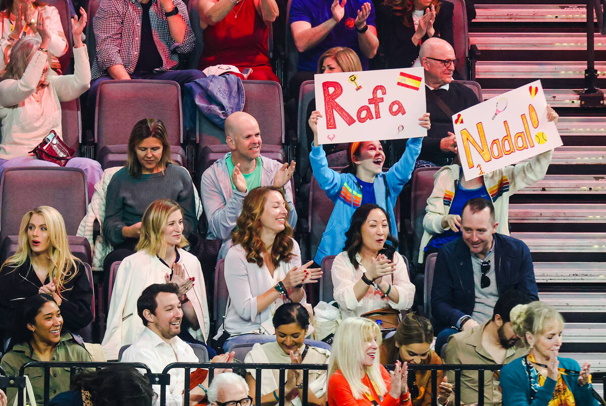 Guests hold up signs supporting Rafael Nadal at the live tennis match the Netflix Slam at Miche ...