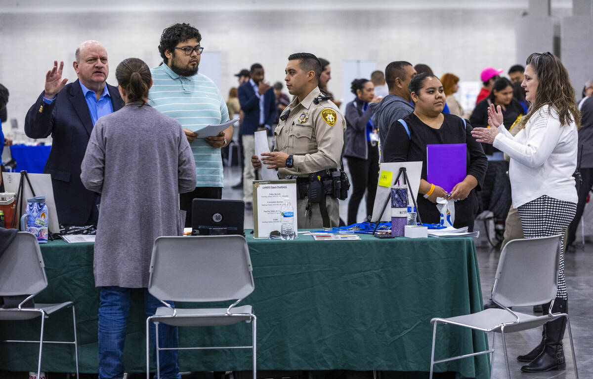 Job seekers speak to staff from the Metropolitan Police Department during the annual Spring Job ...