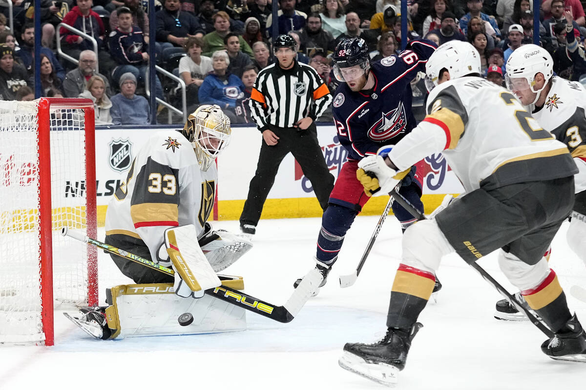 Vegas Golden Knights goaltender Adin Hill (33) blocks a shot in front of Columbus Blue Jackets ...