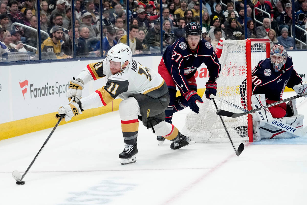 Vegas Golden Knights left wing Mason Morelli (11) skates the puck around the back of the net in ...