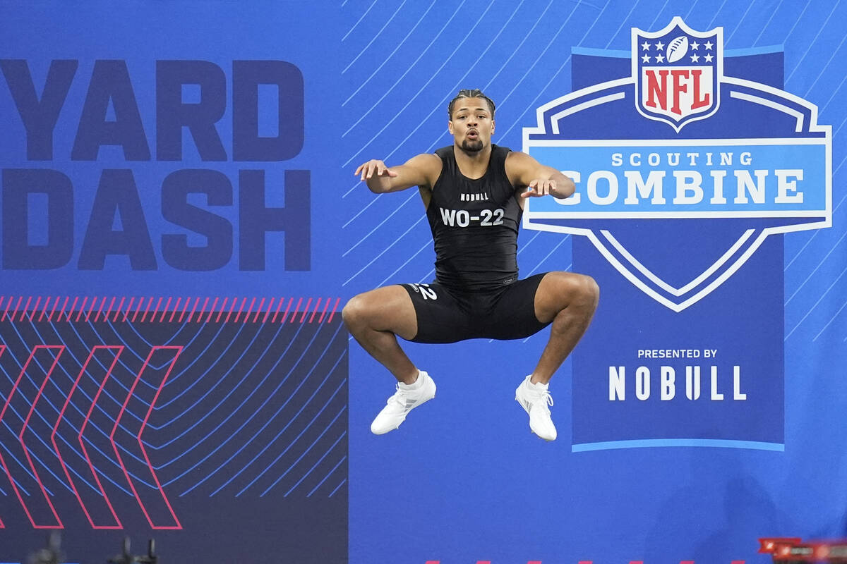 Washington wide receiver Rome Odunze runs a drill at the NFL football scouting combine, Saturda ...