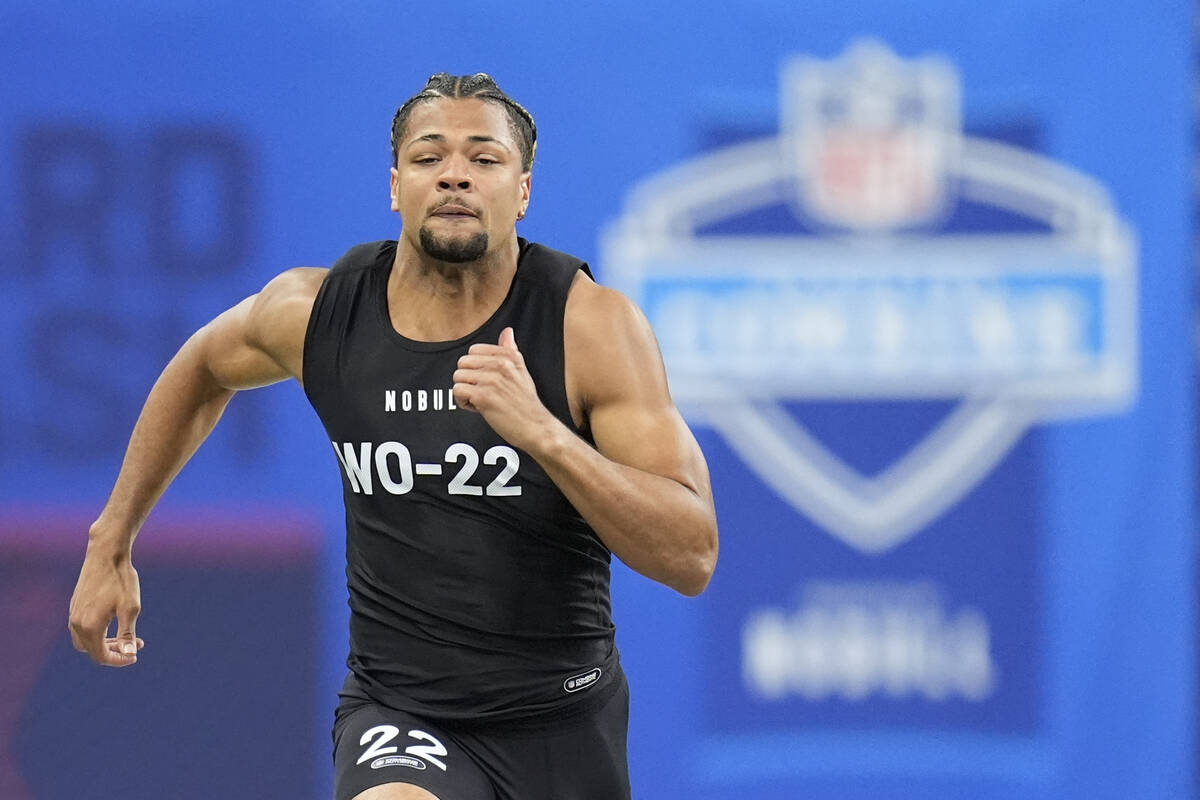 Washington wide receiver Rome Odunze runs a drill at the NFL football scouting combine, Saturda ...