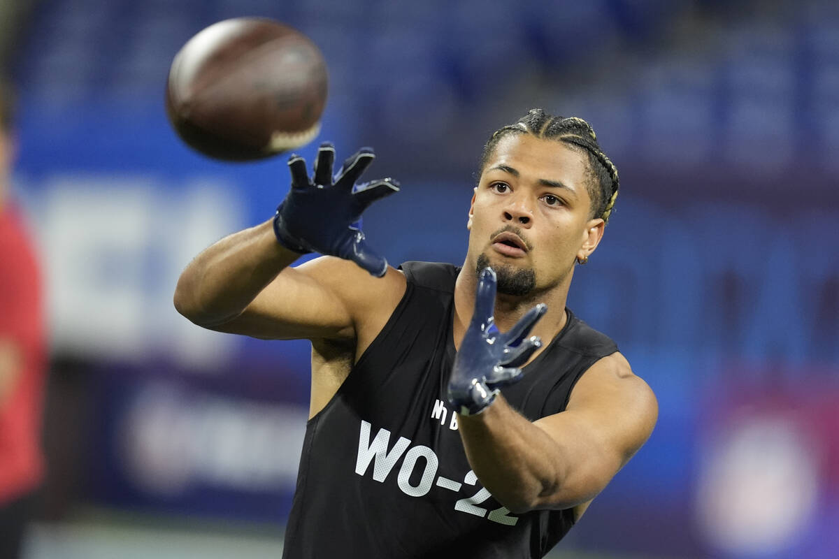 Washington wide receiver Rome Odunze runs a drill at the NFL football scouting combine, Saturda ...