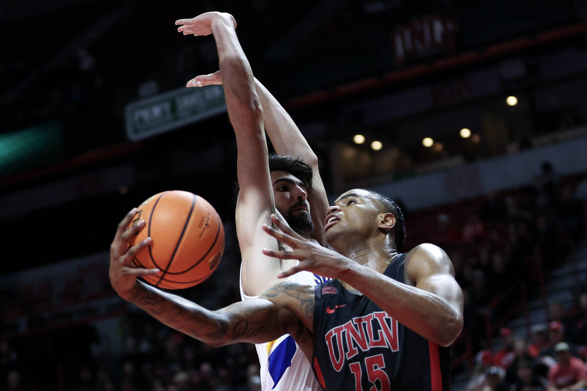 UNLV Rebels guard Luis Rodriguez (15) shoots against San Jose State Spartans forward Tibet Gore ...