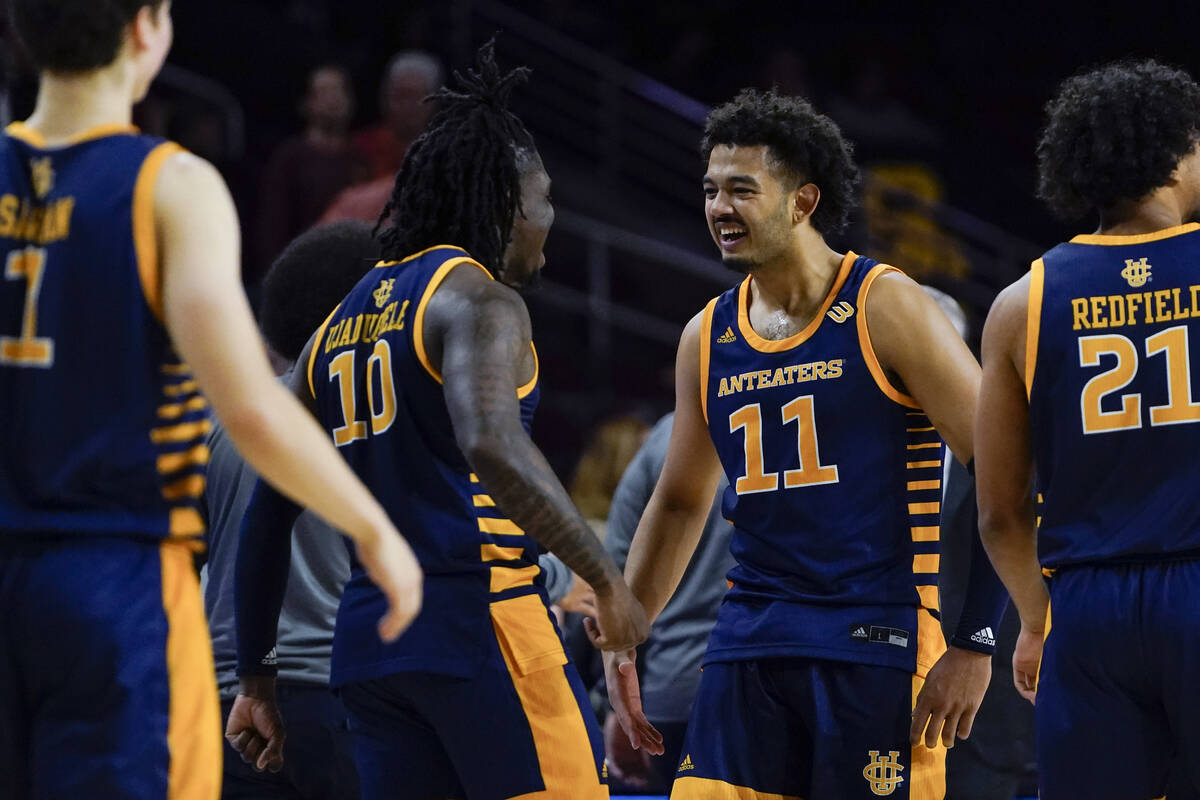 UC Irvine guard Ofure Ujadughele (10) and forward Devin Tillis (11) smile after the team's win ...