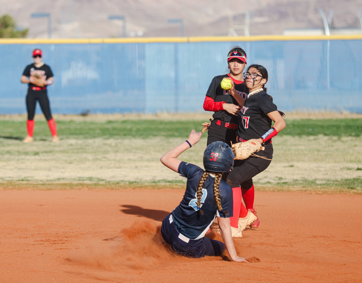 Liberty High School’s Dani Luevanos (17) goes to throw to first base after forcing out a ...
