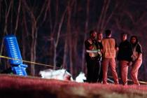 Emergency officials work the scene of a fatal small plane crash alongside Interstate 40 near mi ...