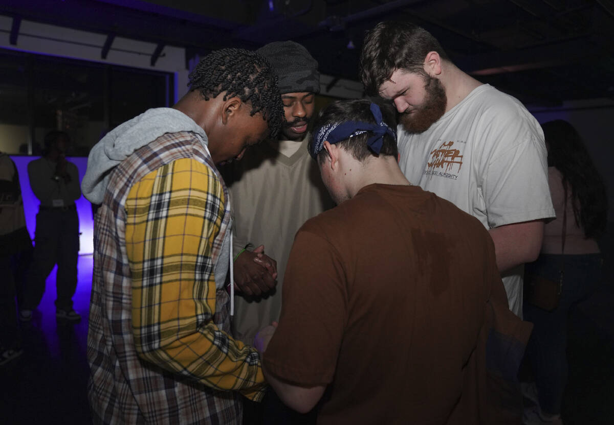 Young clubbers at The Cove, a pop-up, 18-and-up Christian nightclub, pray together after a nigh ...