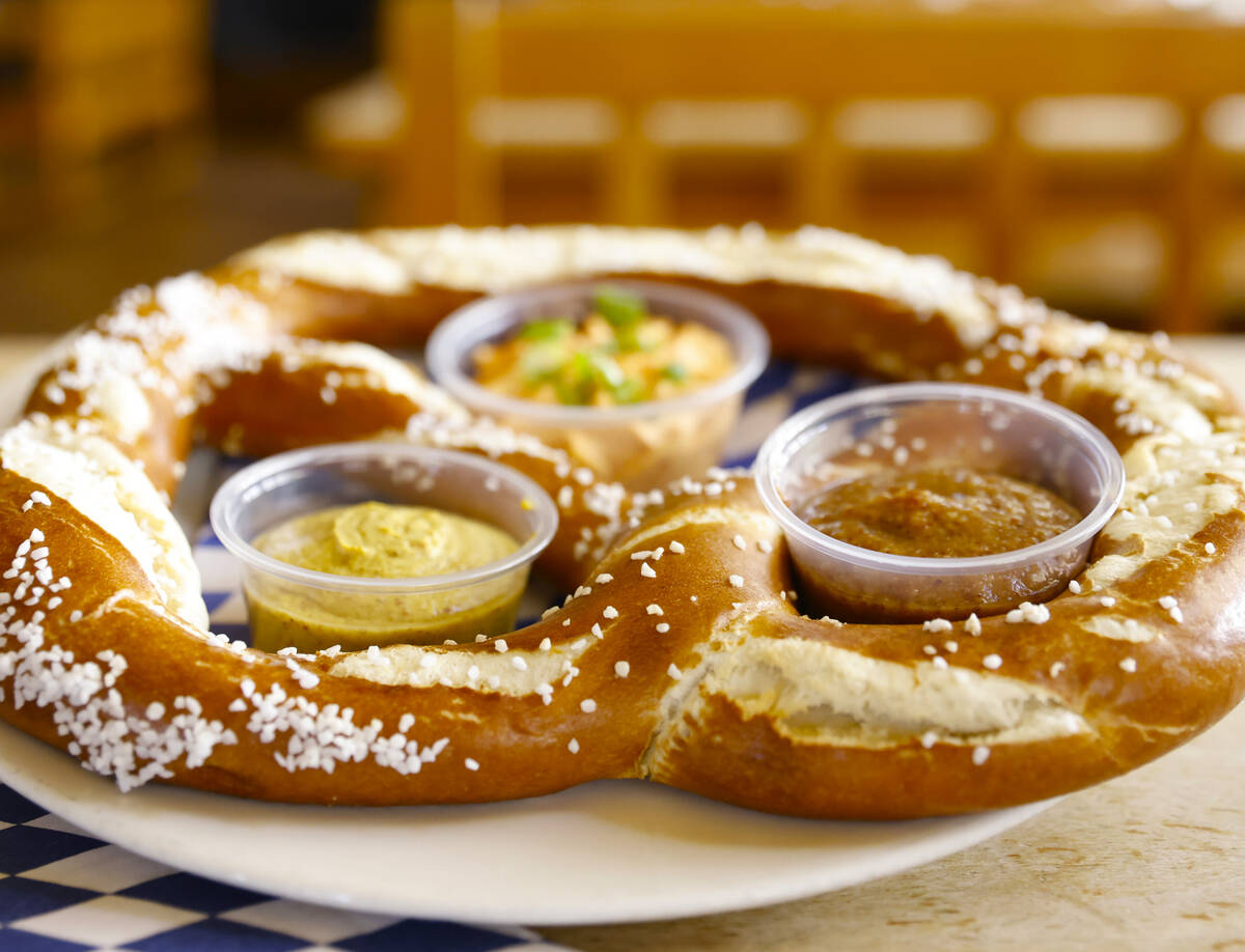 Riesenbrezen Combo, a giant pretzel served with Obatzda cheese, sweet mustard and onion mustard ...