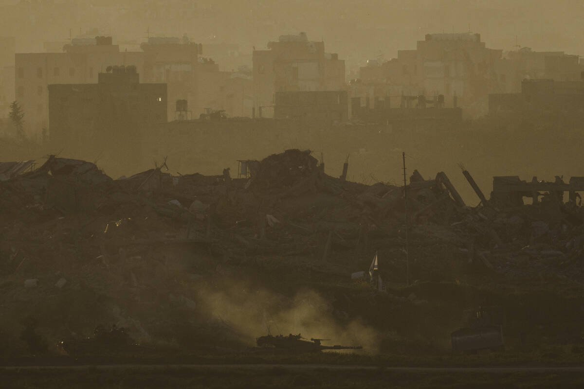 An Israeli army tank moves in the Gaza Strip, as seen from southern Israel, Tuesday, March 5, 2 ...