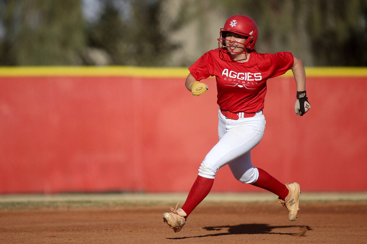 Arbor View shortstop Madilyn Lowy sprints to third base to secure her triple hit during a high ...