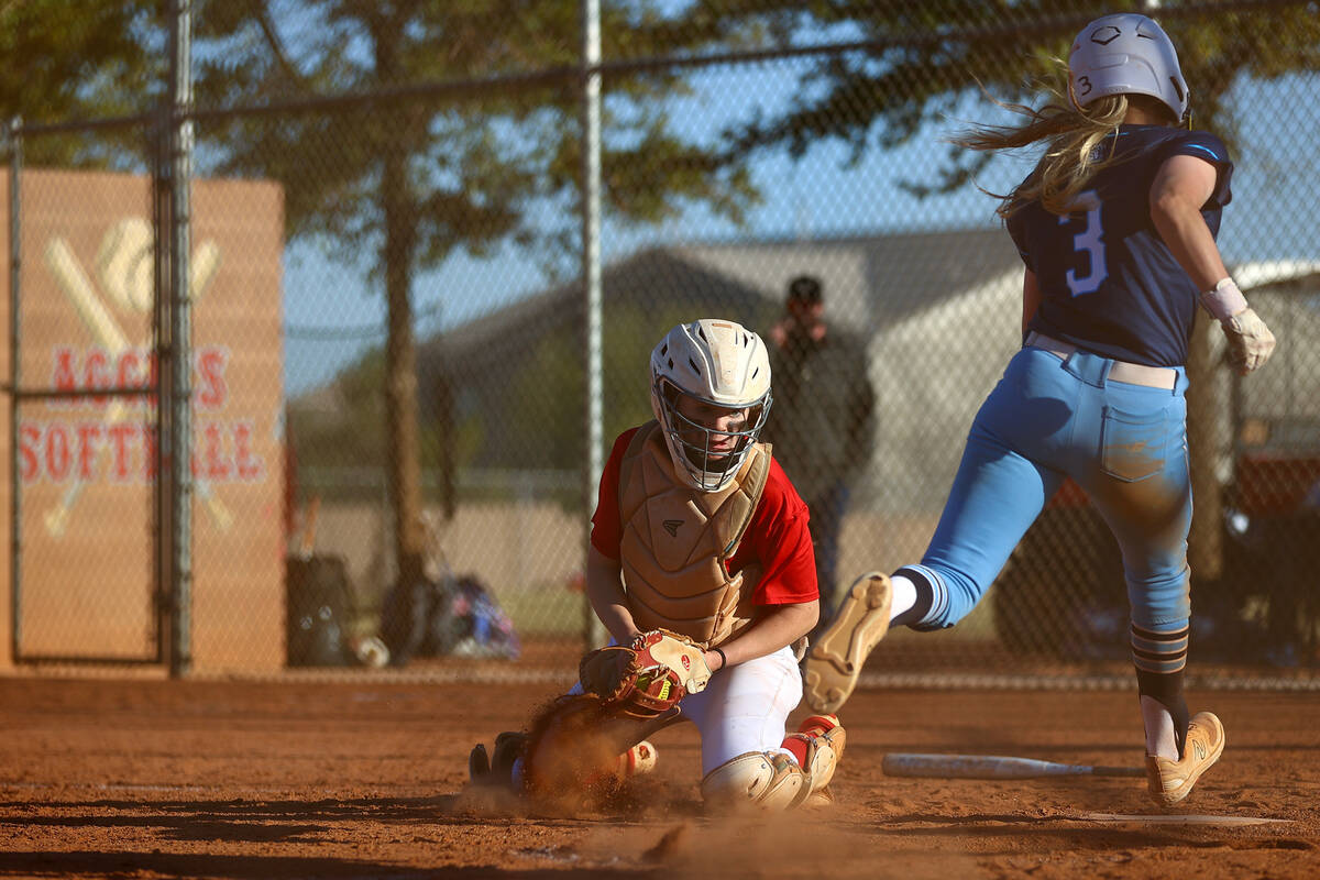 Arbor View catcher Kelsie Phares (39) looks to out Centennial's Ashley Madonia (3) during a hig ...