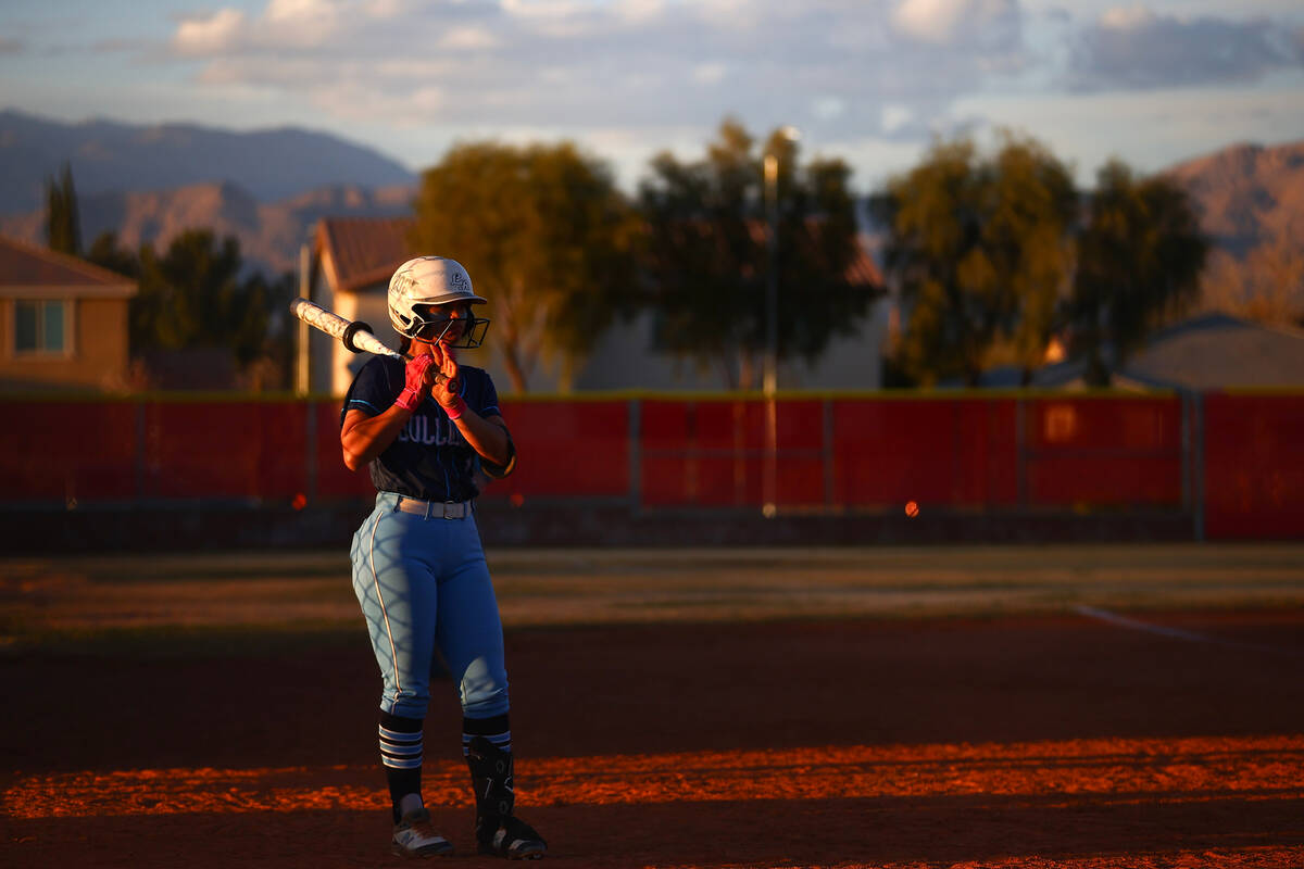 Centennial's Amanda Campos-Colon (13) warms up while she is on deck during a high school softba ...