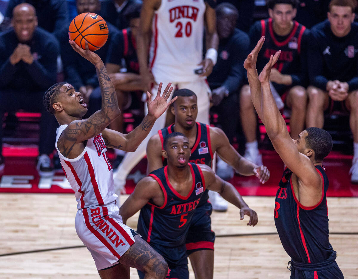 UNLV guard Luis Rodriguez (15) elevates for a shot over San Diego State Aztecs guard Lamont But ...