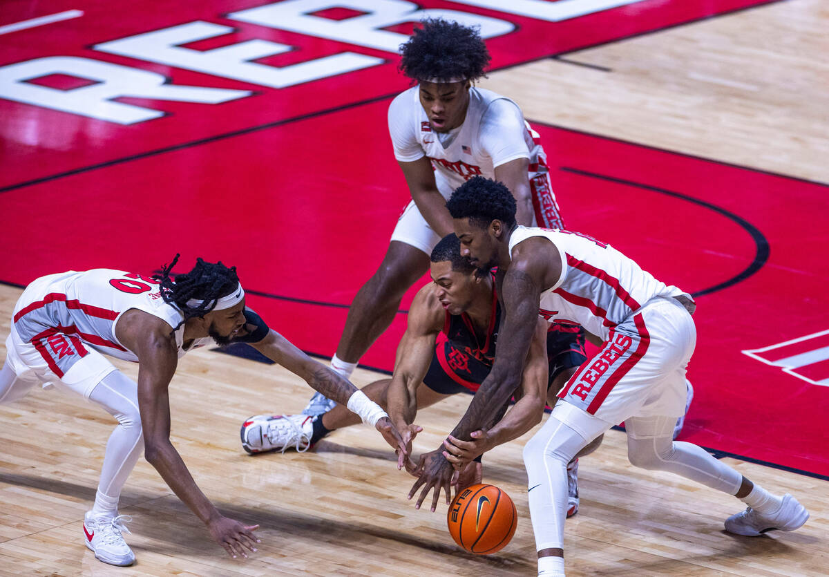 UNLV forward Keylan Boone (20) and forward Kalib Boone (10) fight for a loose ball with San Die ...