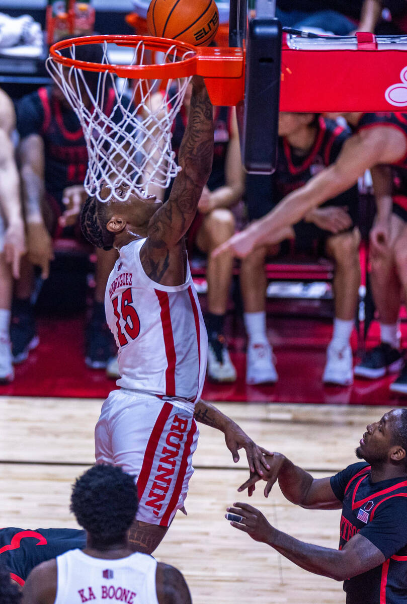 UNLV guard Luis Rodriguez (15) lays in the ball over the San Diego State Aztecs during the firs ...