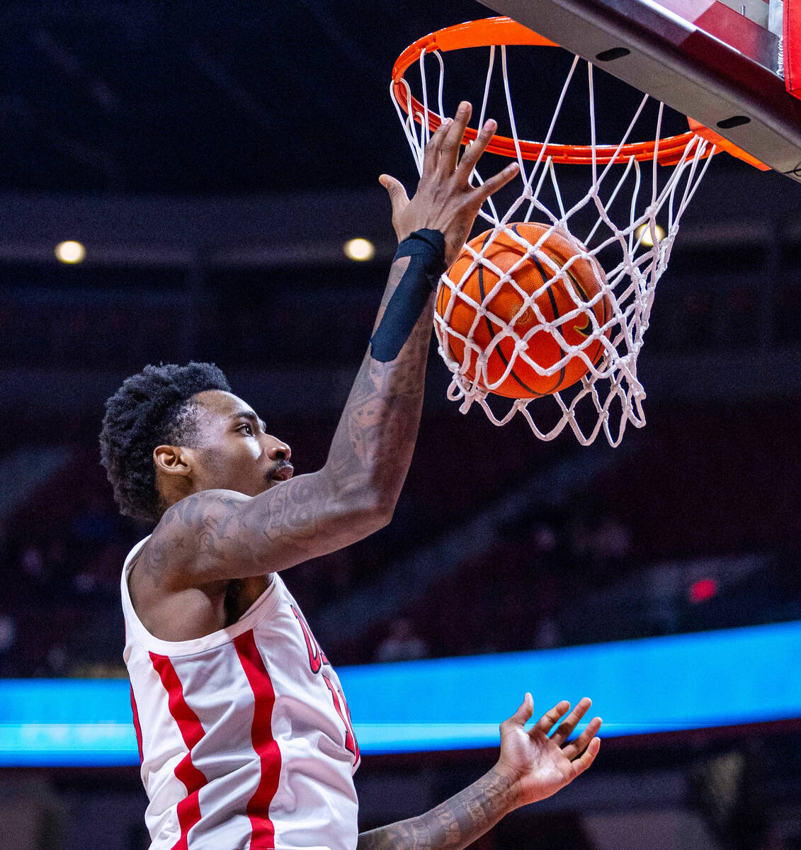 UNLV forward Kalib Boone (10)ensures that a basket counts against the San Diego State Aztecs du ...