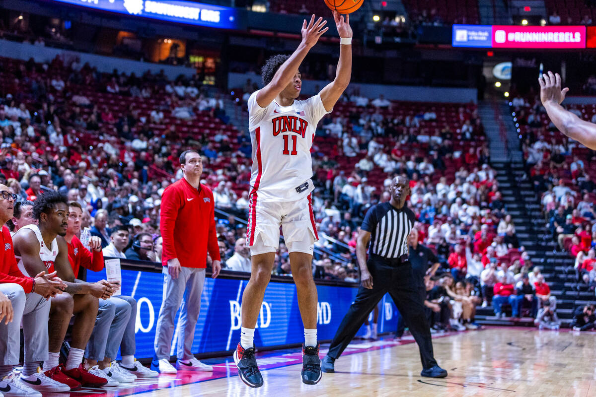 UNLV guard Dedan Thomas Jr. (11) sets up to shoot a three-point basket over the San Diego State ...