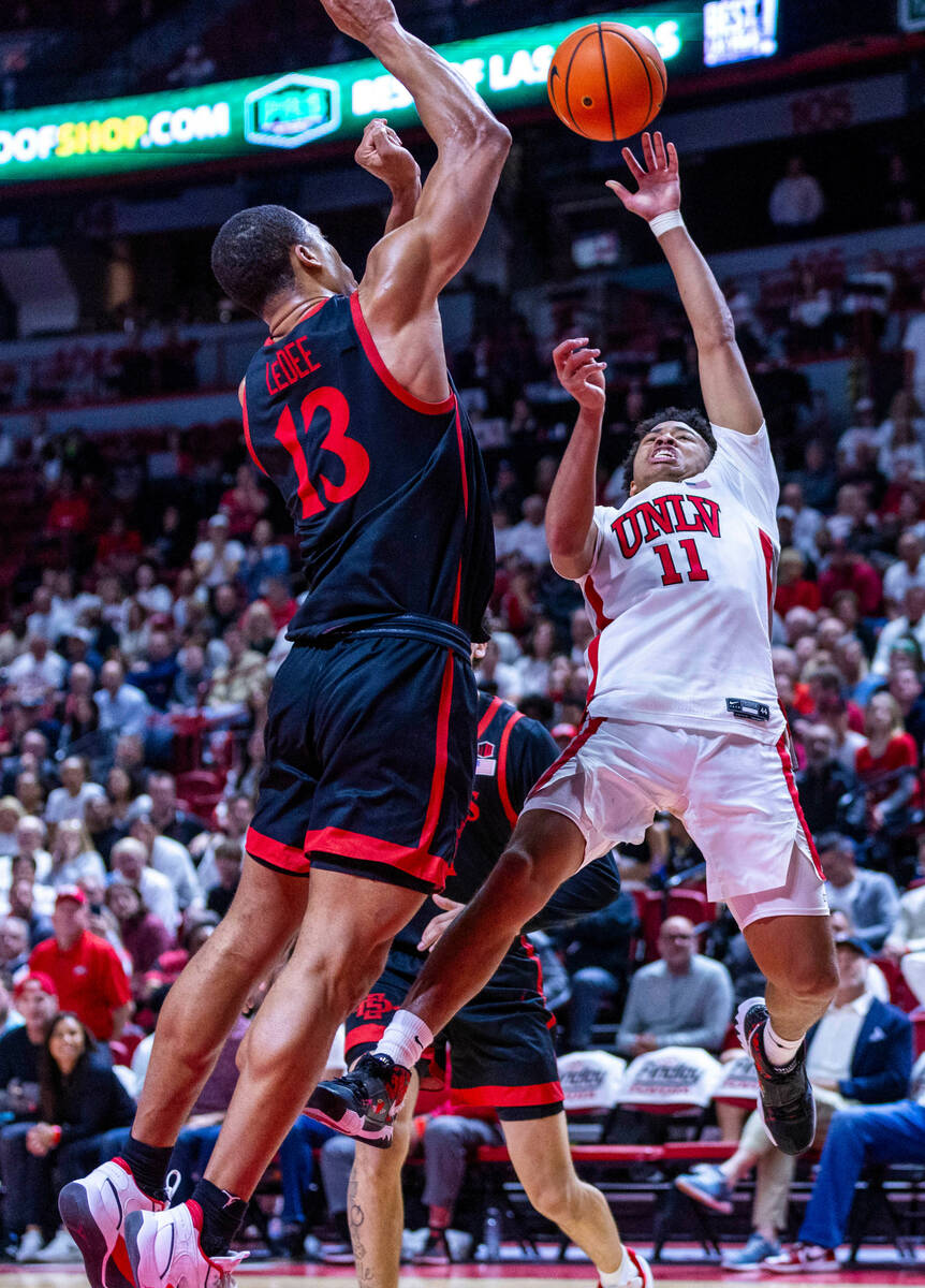 UNLV guard Dedan Thomas Jr. (11) falls back but still shoots over San Diego State Aztecs forwar ...