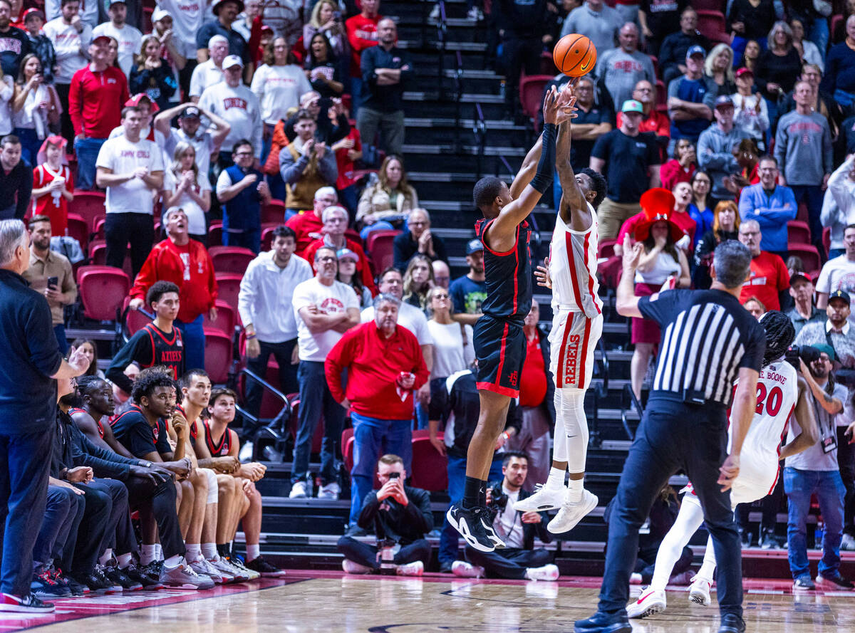 San Diego State Aztecs guard Micah Parrish (3) has a late shot interrupted by UNLV forward Kali ...