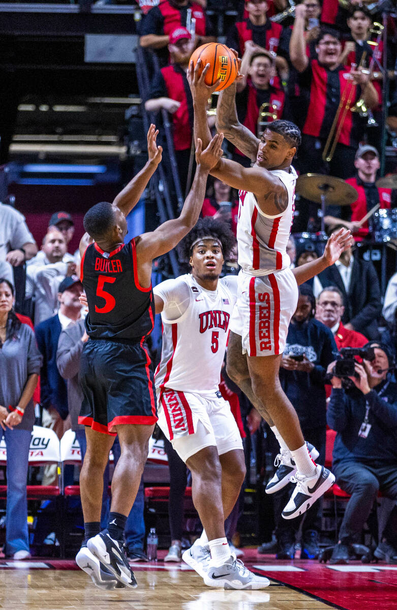 UNLV guard Luis Rodriguez (15) grabs a late rebound over San Diego State Aztecs guard Lamont Bu ...