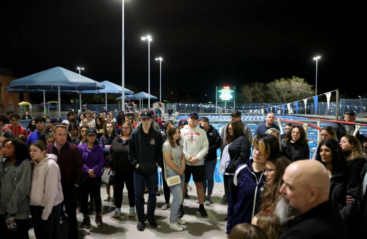 Loved ones of star swimmer Charlie Clark, 19, hold a vigil at Henderson Multigenerational Outdo ...