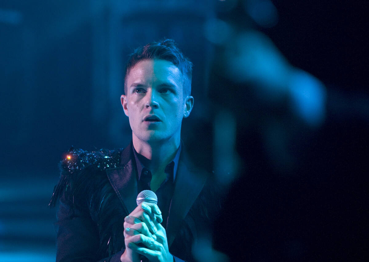 Brandon Flowers of The Killers performs with the band to a sold-out crowd during the opening ni ...