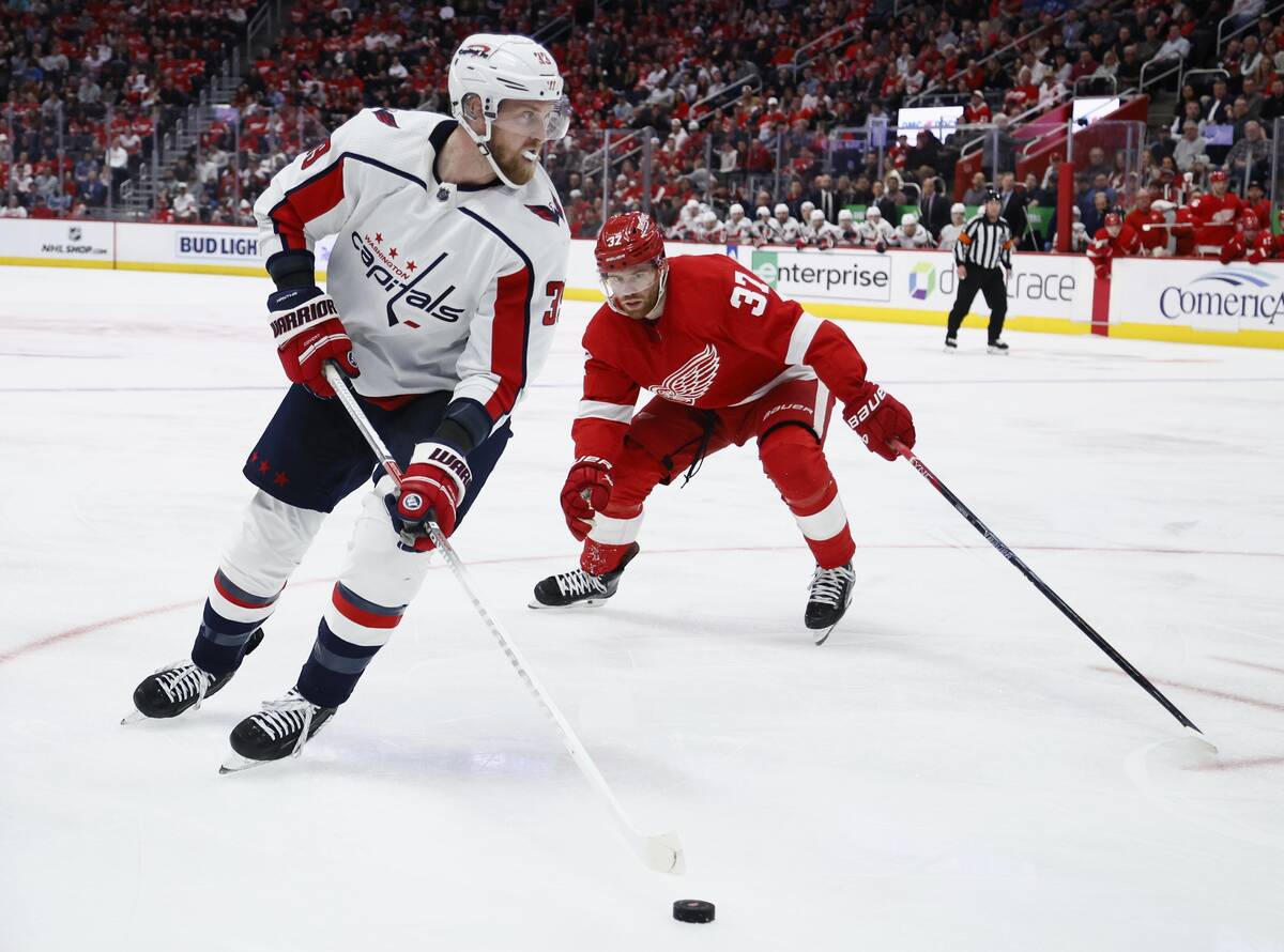 Washington Capitals right wing Anthony Mantha, left, moves the puck against Detroit Red Wings l ...