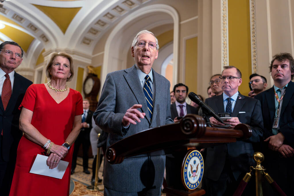 Senate Minority Leader Mitch McConnell, R-Ky., joined from left by Sen. John Barrasso, R-Wyo., ...