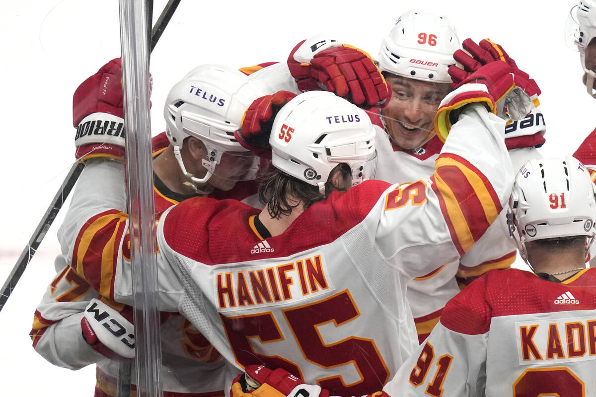 Calgary Flames defenseman Noah Hanifin (55) is congratulated by teammates after his goal agains ...