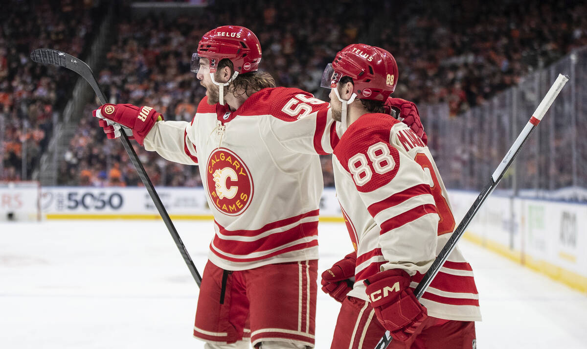 Calgary Flames' Noah Hanifin (55) and Andrew Mangiapane (88) celebrate after a goal against the ...