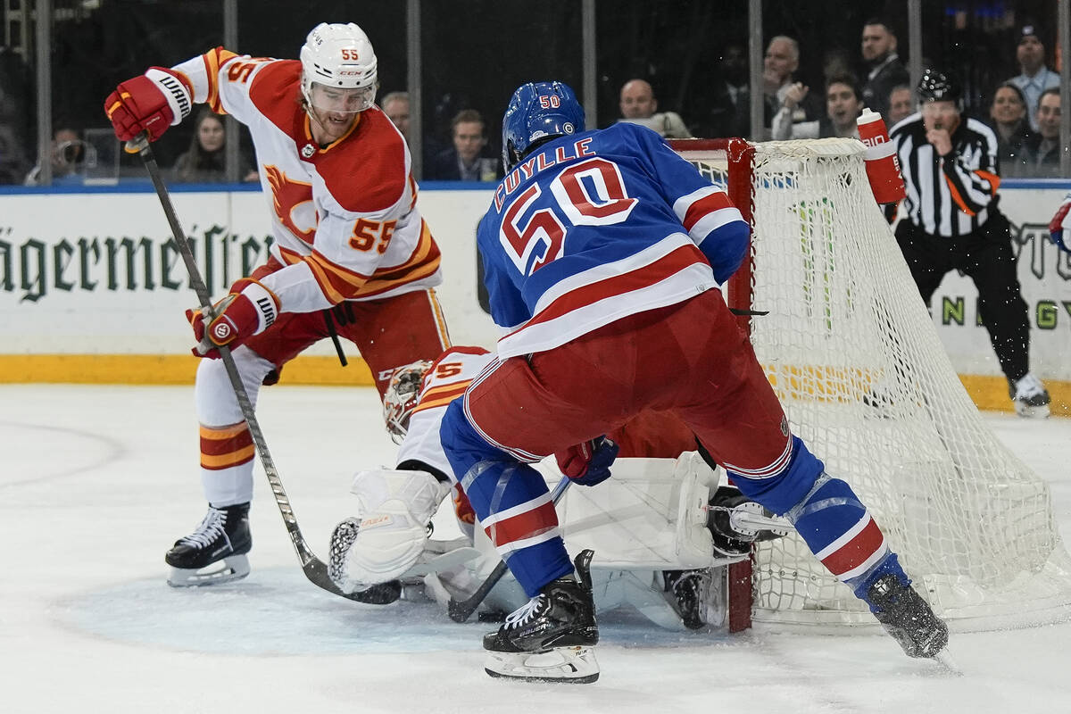 New York Rangers left wing Will Cuylle (50) scores a goal around Calgary Flames goaltender Jaco ...